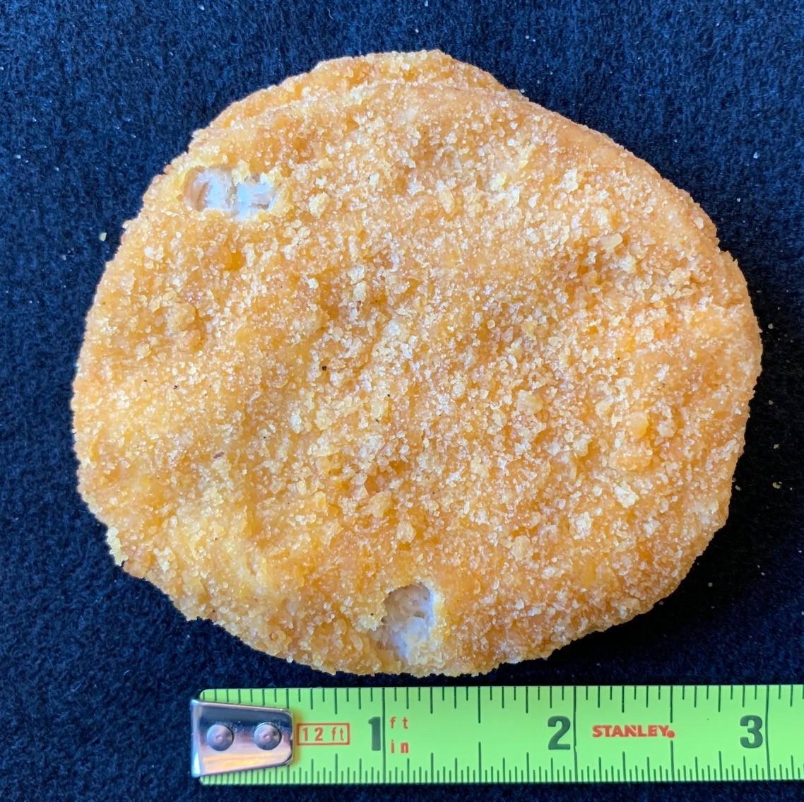 Figure 3. Chicken patty with two breading voids each less than half an inch so there is no defect